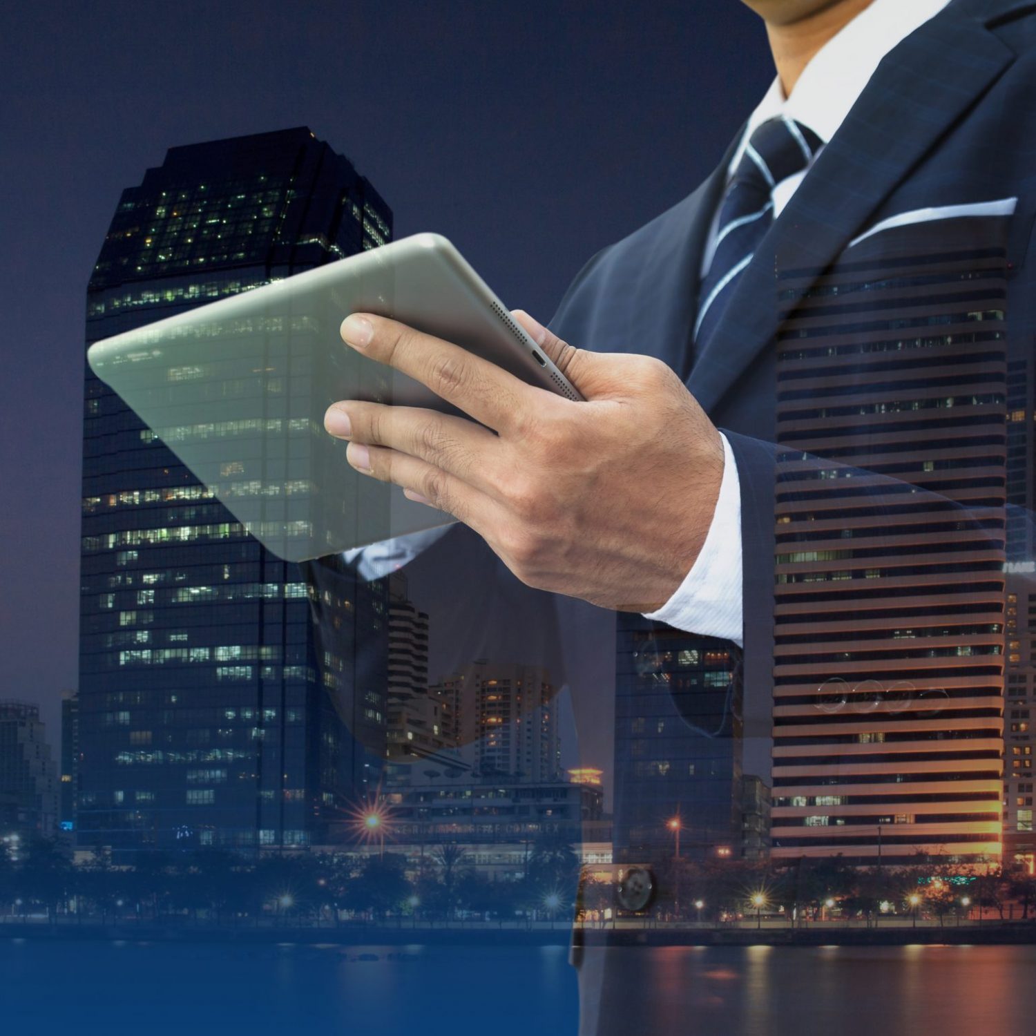 Double exposure of businessman using digital tablet with modern building and social media